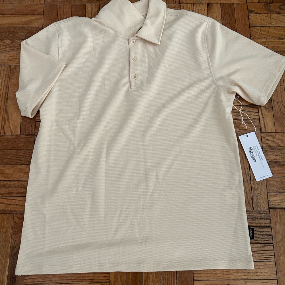 Cream colored Saturdays NYC polo